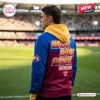Side view of a person wearing a Brisbane Lions AFL 2026 Grand Final Premiers Hoodie with back-to-back graphics at a stadium.