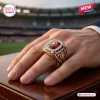 Closeup of a gold Brisbane Lions AFL championship ring worn on a hand.