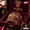 Front view of Brisbane Lions AFL Premiers Distressed Cap resting inside a lined presentation box.