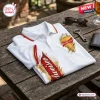 Top view of a white Budweiser beer polo shirt with a red and gold collar, sleeve trim, and branded graphic print.