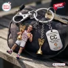 Close-up of a Caitlin Clark USA Basketball 2026 World Cup keychain attached to a gray bag with keys.
