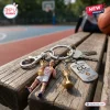 Close-up of a Caitlin Clark USA Basketball 2026 World Cup keychain resting on a wooden bench.
