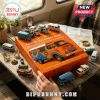 Campervan Christmas Advent Calendar 2026 orange box with miniature vintage vans, campfire, and road map on a wooden table.