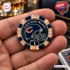 Closeup of a Chicago Bears poker chip with a football helmet graphic and crystal accents held between two fingers.