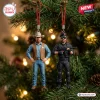 Chuck Norris 2026 Walker Texas Ranger Advent Calendar resin ornaments hanging on a Christmas tree with warm blurred lights.
