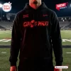 Front view of a black hoodie with red Cincinnati text graphic worn on a football field.