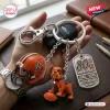 Closeup of Cleveland Browns 80th Anniversary Metal Keychain held in hand with helmet and dog charms.