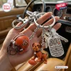 Closeup of Cleveland Browns 80th Anniversary Metal Keychain held in hand inside a car.