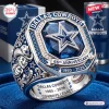 Closeup of a Dallas Cowboys 66th Anniversary commemorative ring featuring a blue stone and a central star emblem.
