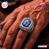 Closeup of a hand wearing a silver Dallas Cowboys 66th Anniversary commemorative ring with a blue star centerpiece.