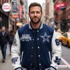 Front view of a man wearing a blue and white Dallas Cowboys Football Mascot Baseball Jacket on a city street.