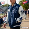 Front view of a blue and white Dallas Cowboys football mascot baseball jacket worn outdoors.