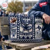 Dallas Cowboys NFL crocheted tote bag featuring team logos, AT&T Stadium icon, and football motifs in blue and white yarn.