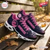 Side view of Dallas Cowboys x Breast Cancer Awareness Air Max Plus Sneakers on a wooden bench.