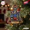 Front view of a pyramid-shaped Def Leppard album cover Christmas ornament hanging on a pine tree.