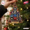 Hand holding a pyramid-shaped Def Leppard album cover Christmas ornament on a decorated tree.
