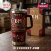 Depeche Mode 46th Anniversary YETI Stanley Tumbler featuring red tie-dye graphics, DM logo, and band members on a wood table.
