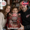 Detroit Red Wings 100th Anniversary 2026 Advent Calendar held by a family featuring red hockey graphics and anniversary text.