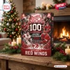 Front view of Detroit Red Wings 100th Anniversary Christmas Advent Calendar on a wooden table near a lit fireplace.