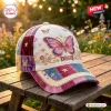 Front view of the Dolly Butterfly Patchwork Baseball Cap with floral embroidery on a wooden table.