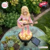 High angle view of a Dolly Parton solar garden light figurine holding a guitar with illuminated base.
