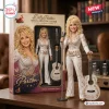 Front view of the Dolly Parton Tribute Collector Edition Figure standing beside its packaging box and a miniature guitar.