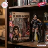 Figure of a character in black corset and fishnets standing next to its branded display box on a wooden shelf.