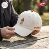 Close-up of a cream-colored Dunkin Donuts Chicago Bears baseball cap with an embroidered iced coffee and team logo.