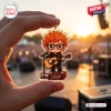 Close-up of a hand holding an Ed Sheeran Loop Tour 2026 acrylic keychain against a sunset concert background.