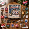 Front view of EMT On The Way Advent Calendar surrounded by 24 acrylic ornaments on a wooden table.