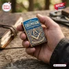 Freemason lighter case featuring blue enamel, gold accents, and the square and compass symbol held in a person's hand.