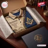 Top view of a Freemasonry Brotherhood Premium Polo Shirt in a gift box with gold masonic symbols and text.