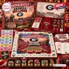 Top view of Georgia Bulldogs Collector Edition Monopoly game components including board, money, tokens, and storage box.