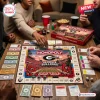 High angle view of a group playing Georgia Bulldogs Collector Edition Monopoly on a wooden table.