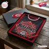 Top view of a black t-shirt with Georgia Bulldogs mascot graphic inside a gift box on a wooden table.