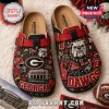 Georgia Bulldogs Sanford Stadium Suede Clogs featuring team red and black graphics, a bulldog mascot, and stadium imagery.