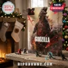Godzilla 24-Piece Figurine Advent Calendar featuring numbered doors and monster figures on a wooden holiday table.