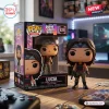 Front view of Lucia Funko Pop vinyl figure standing beside its branded cardboard display box on a wooden desk.