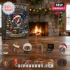 Grateful Dead 60th Anniversary 24-Piece Holiday Advent Calendar box next to small themed figurines on a wooden table.