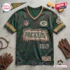 Front view of a distressed Green Bay Packers football t-shirt featuring the team logo and 1919 text on a concrete surface.