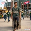 Man wearing a green Green Bay Packers distressed T-shirt with vintage style text and graphics at a stadium.