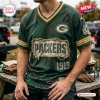 Front view of a distressed green Green Bay Packers football t-shirt featuring 1919 text and weathered patch details.
