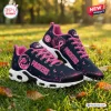Side view of Green Bay Packers x Breast Cancer Awareness Air Max Plus Sneakers on grass.