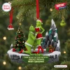 Front view of a Grinch couple funny Christmas ornament with a green character kneeling before a partner on a stone base.