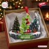 Front view of a Grinch couple funny Christmas ornament in a gift box with a personalized plaque.