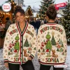 Front and back view of a woman wearing a cream holiday ugly cardigan with green character and dog graphics.