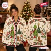 Front and back view of a person wearing a cream holiday cardigan featuring green character graphics and custom text.