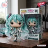 Front view of the Hatsune Miku 20th Anniversary Vinyl Figure standing beside its branded box.