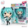 Front view of Hatsune Miku 20th Anniversary Vinyl Figure holding a microphone next to its retail box.