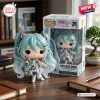 Front view of the Hatsune Miku 20th Anniversary Vinyl Figure standing beside its collectible box.